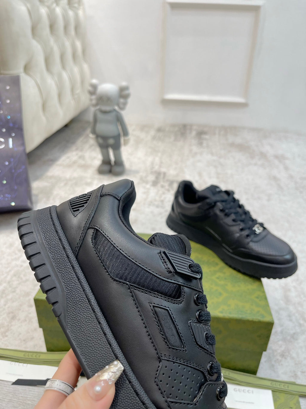 Gucci unisex lace-up sneakers, dark navy side view, lace holes and rubber tread