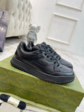 Gucci unisex lace-up sneakers, dark navy textured upper, rubber tread sole