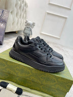 Gucci unisex lace-up sneakers, dark navy textured upper, rubber tread sole