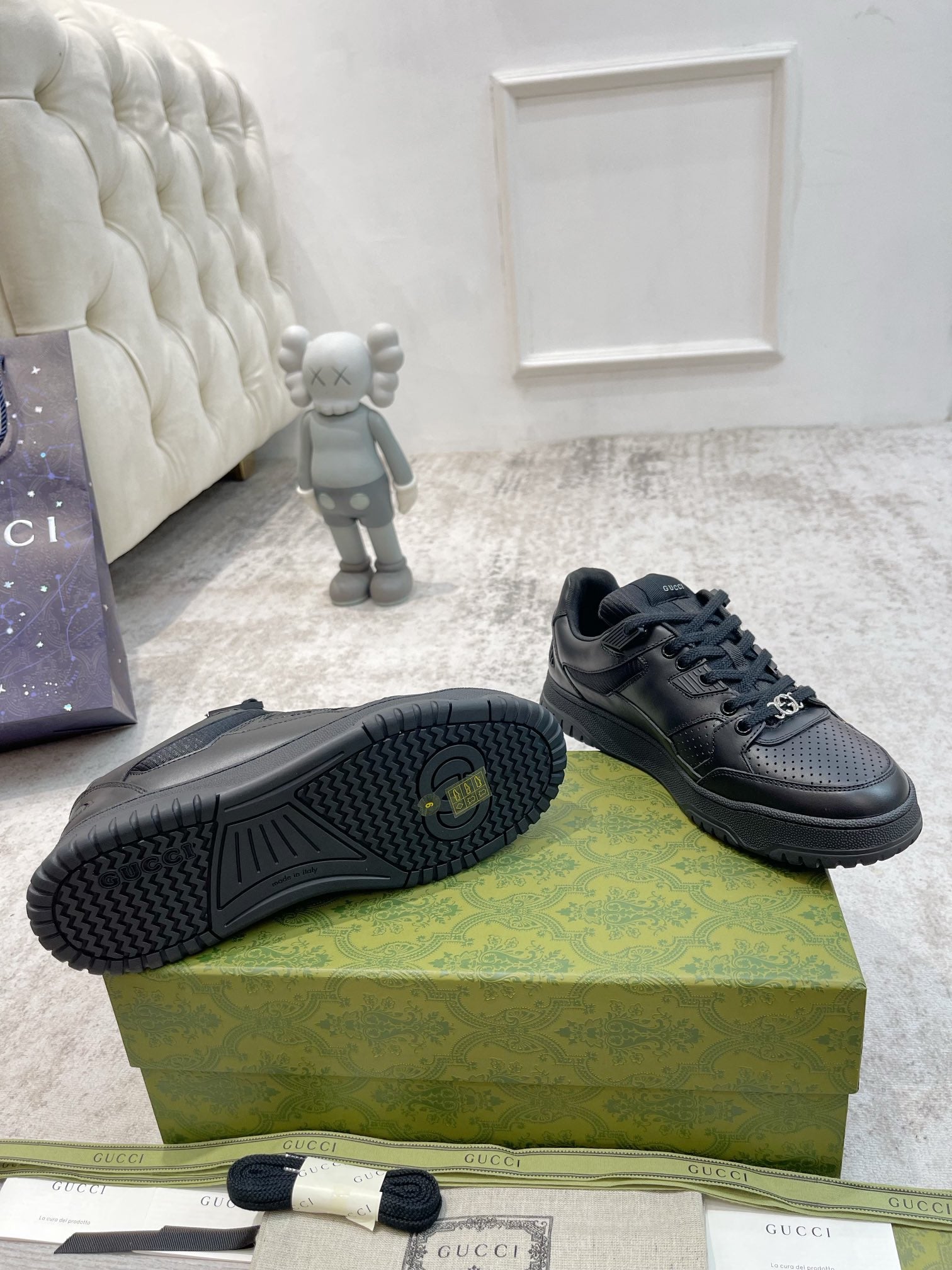 Gucci unisex sneakers outsole view, dark rubber tread with lace-up upper