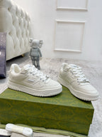 Gucci unisex luxury sneakers, white pair with lace-up and side logo on chunky sole