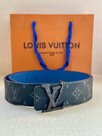 Louis Vuitton monogram belt with dark blue strap and prominent metal buckle center