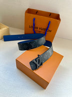 Louis Vuitton monogram belt laid flat with blue strap and metal buckle detail