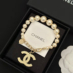 Chanel pearl bracelet with gold-tone chain and large rocking-horse charm