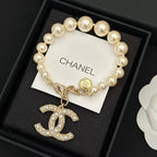 Chanel pearl bracelet with gold-tone chain and jeweled rocking-horse charm