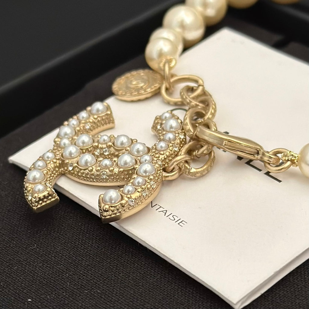 Chanel pearl bracelet with gold-tone horse charm and pearl-like rhinestone details
