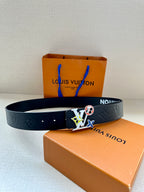Louis Vuitton belt laid out with multicolor charm buckle on dark navy strap