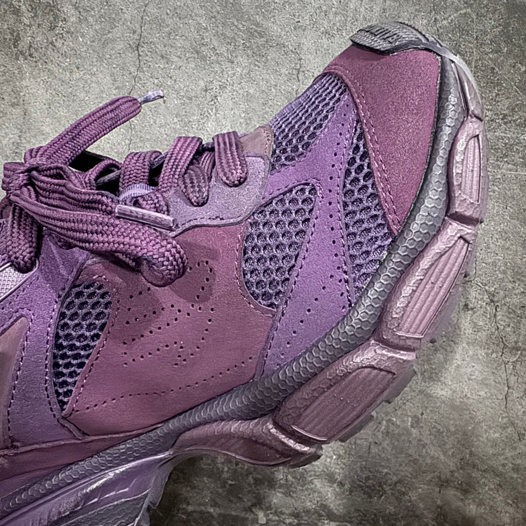 Purple sneaker side view with mesh panels, suede trim, and chunky midsole