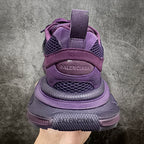 Purple sneakers with lace-up closure, padded heel, and Balenciaga logo on back