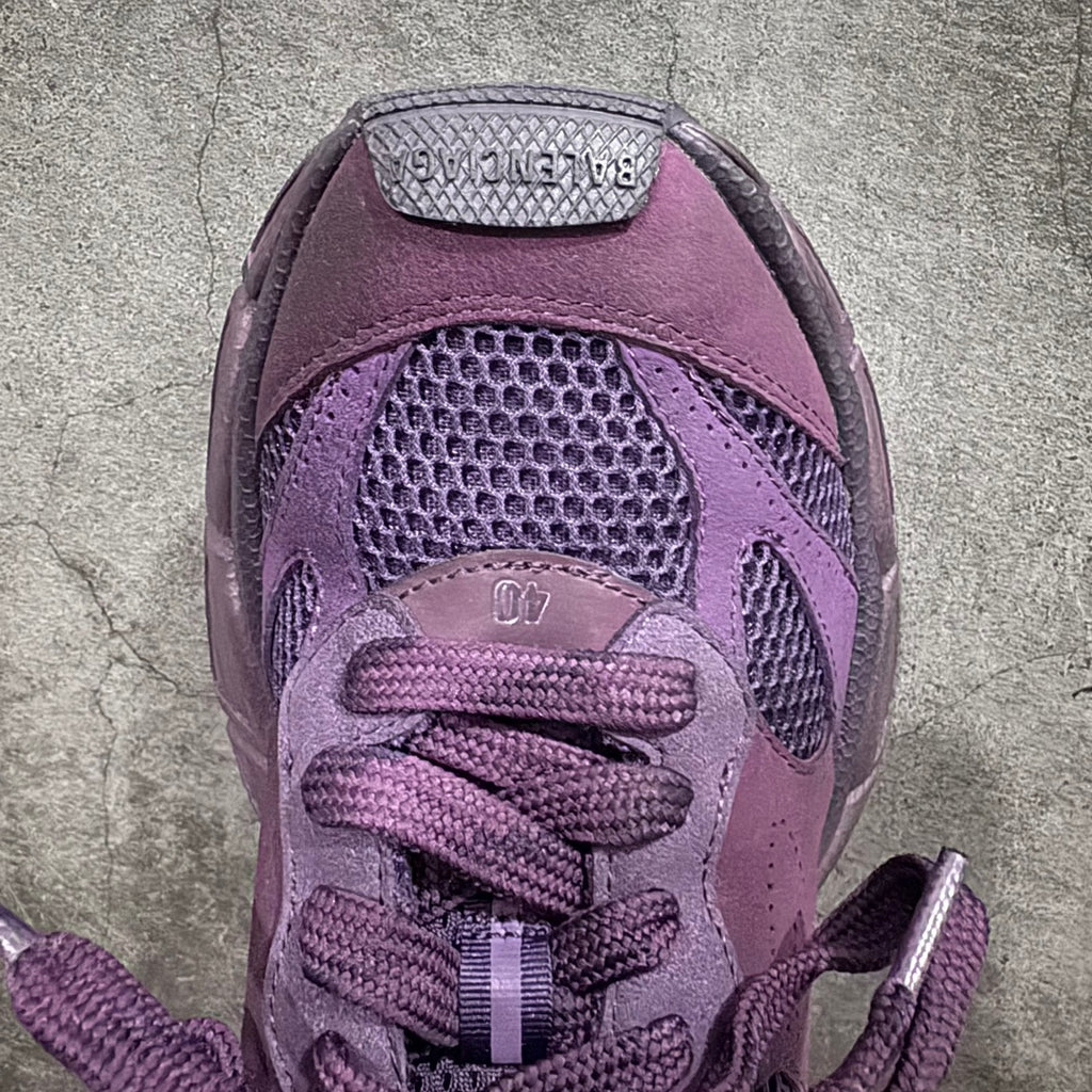 Purple sneakers close-up of laces and textured mesh panel on tongue