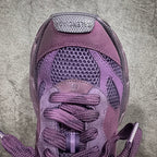 Purple sneakers close-up of laces and textured mesh panel on tongue