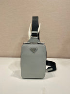 Prada mini crossbody bag, light gray with black strap and triangular logo plaque
