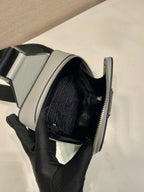 Prada mini bag interior, light gray exterior with black-lined main compartment