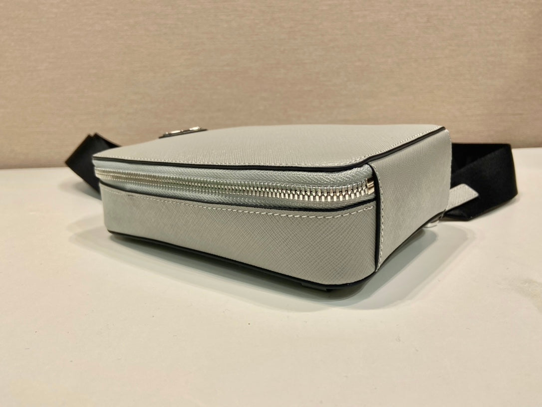 Prada mini bag, light gray side profile with silver zipper and black strap