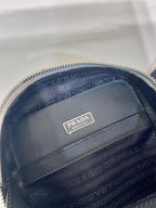 Prada mini bag lining close-up, navy patterned fabric with Prada logo patch