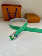 Louis Vuitton belt with green monogram strap and silver buckle, laid flat