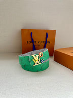 Louis Vuitton belt with green monogram strap and silver buckle with multicolor charm