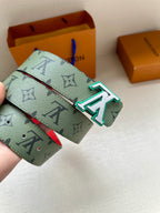 Louis Vuitton belt end with green monogram strap and silver buckle with teal accents