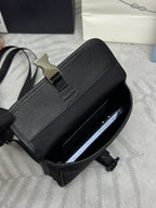 Prada bag open top view with strap and metal clasp hardware, dark textured exterior