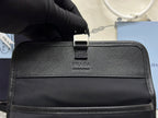 Prada bag front panel with small center logo tag and adjustable strap, dark finish