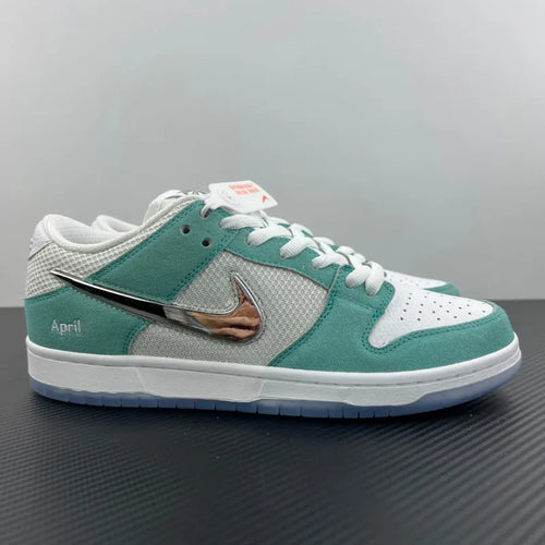 Low-top skate sneakers with teal and gray panels, white laces, and silver Swoosh detail