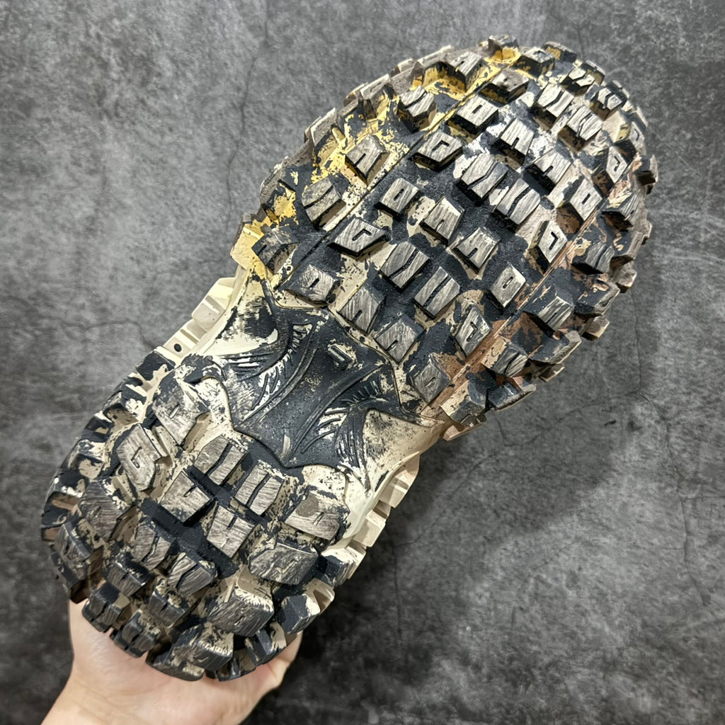 Balenciaga unisex sneakers outsole close-up, off-white lug tread with dark rubber