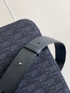 Dark crossbody bag with front strap and textured fabric flap detail