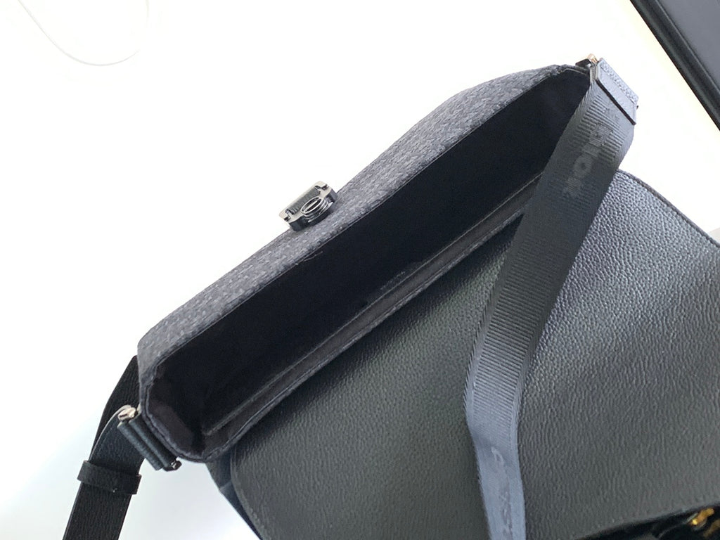 Dark crossbody bag interior view with zipper and top flap open