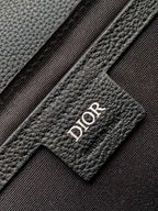 Dark leather bag patch with Dior logo stitching detail