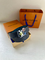 Louis Vuitton belt on packaging: dark monogram strap with turquoise lining and colorful logo buckle.