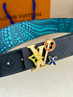 Louis Vuitton belt close-up: dark monogram leather with colorful emblem buckle and prong.