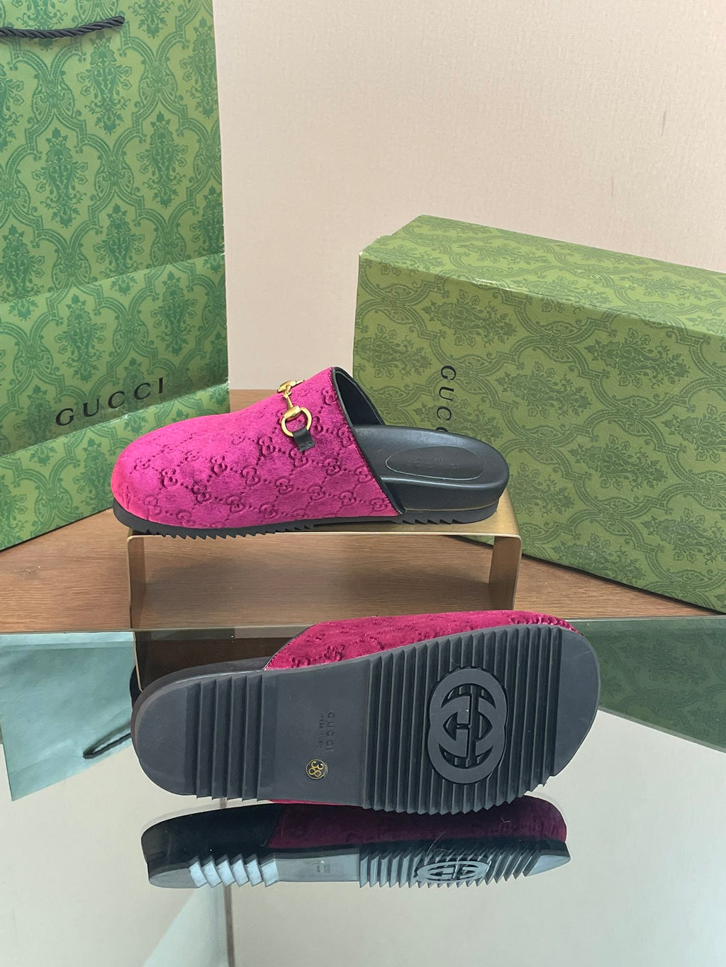Pink velvet slide sandals with treaded black sole and gold hardware