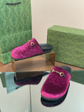 Pink velvet slide sandals with gold horsebit detail and black rubber sole