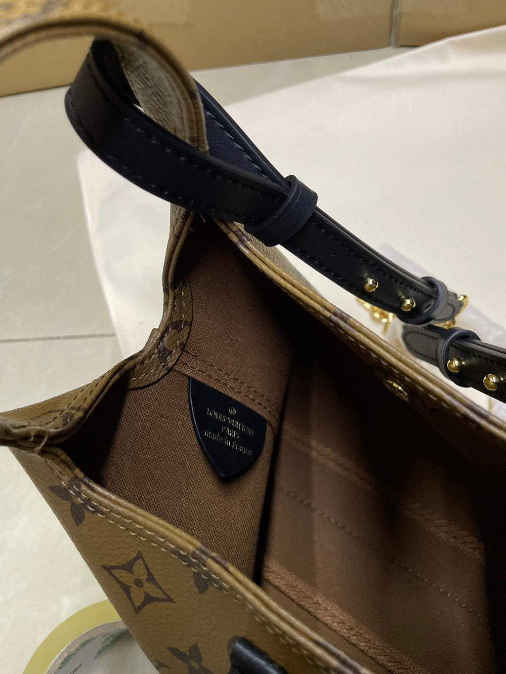 Louis Vuitton monogram handbag base with navy handle strap and interior label