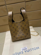 Louis Vuitton monogram mini handbag with top handles, navy trim and gold chain