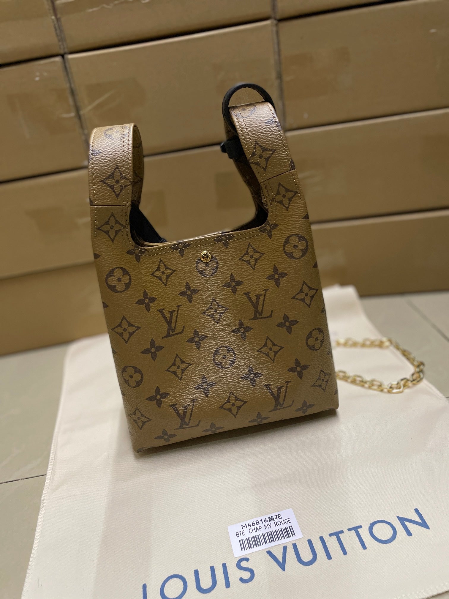 Louis Vuitton monogram mini handbag with top handles, navy trim and gold chain