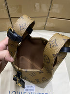 Louis Vuitton monogram handbag with navy trim, top handles and gold buckles
