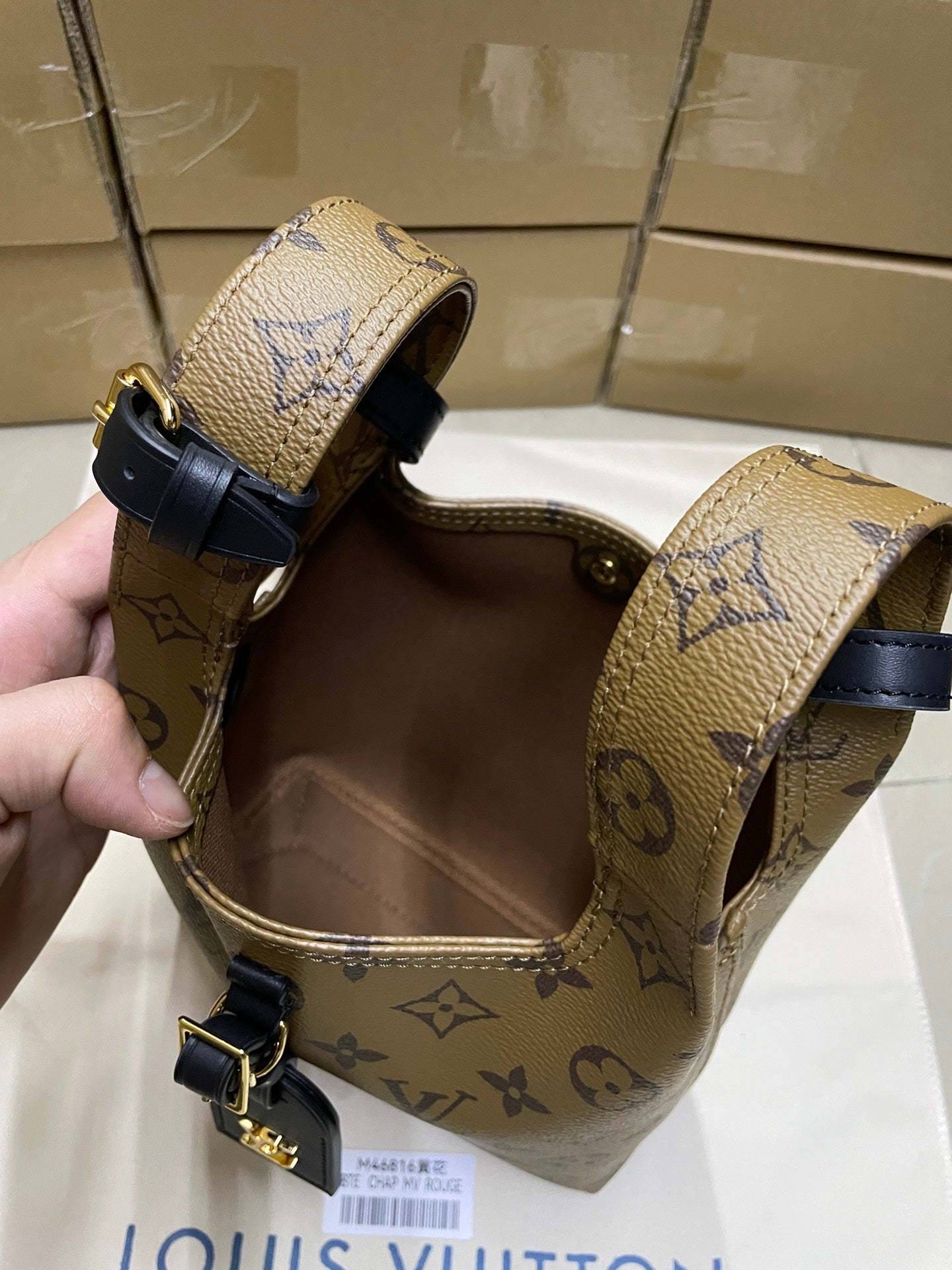 Louis Vuitton monogram handbag with navy trim, top handles and gold buckles
