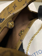Louis Vuitton monogram handbag open top with tan lining and navy leather strap