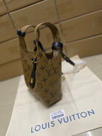 Louis Vuitton monogram handbag with navy top straps and adjustable buckle hardware