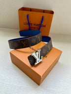 Louis Vuitton belt on box with dark monogram canvas and blue strap, silver LV buckle