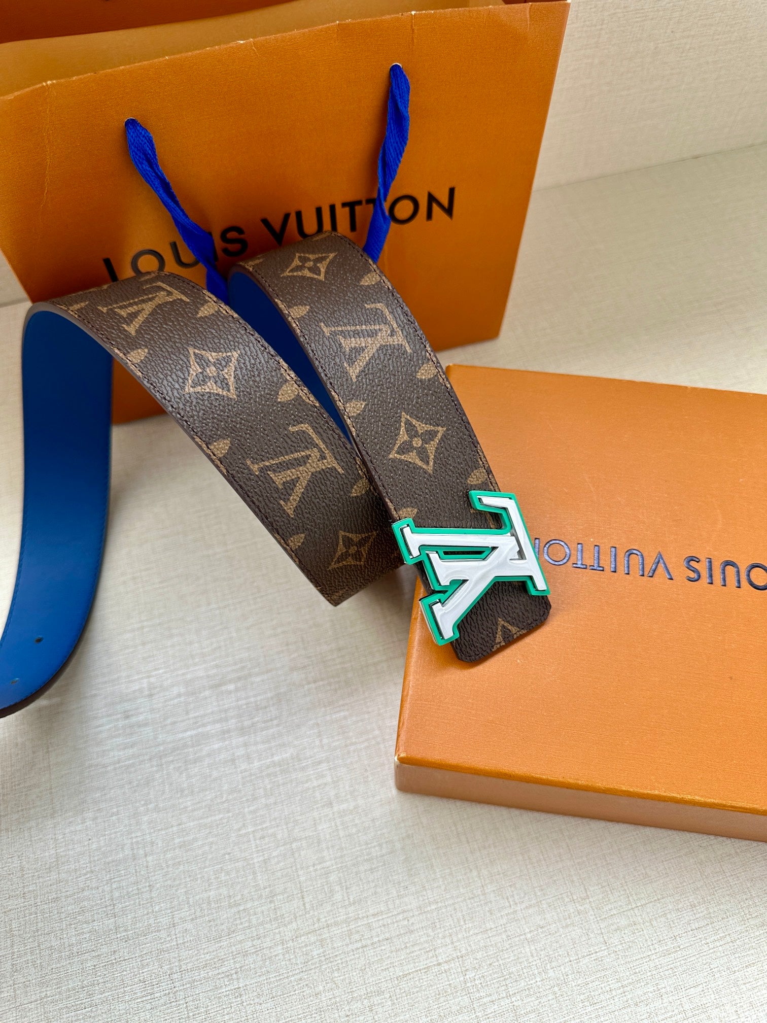 Louis Vuitton belt with dark monogram canvas and blue leather strap, oversized LV buckle