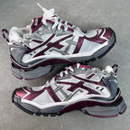 Unisex chunky lace-up sneakers by Balenciaga in white with maroon and gray detailing.