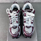 Unisex Balenciaga sneakers with white laces and maroon heel accents on both shoes.
