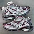 Unisex chunky lace-up sneakers by Balenciaga in white and maroon with gray details.