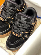 Louis Vuitton trainer shoes close-up, black suede with embossed LV patch and laces