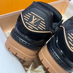 Louis Vuitton trainer shoes heel view, black upper with LV emblem and tan rubber sole