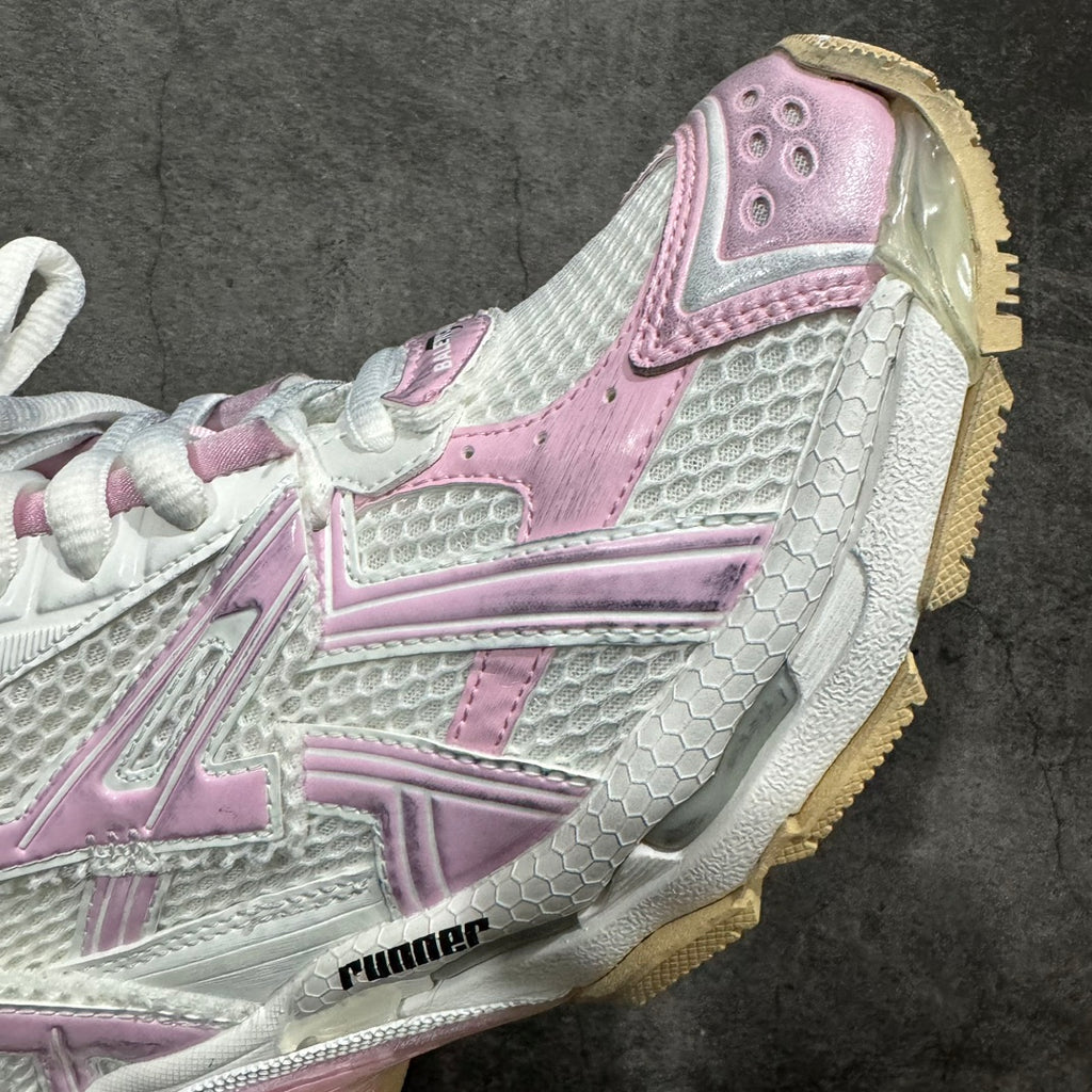 Balenciaga unisex sneaker close-up with mesh panels and pink logo strip