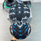 Unisex sneaker outsole tread, black with blue lugs and gray sidewall grooves.