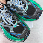 Unisex sneaker instep close-up, black mesh, gray overlays, blue stripes, green midsole edge.